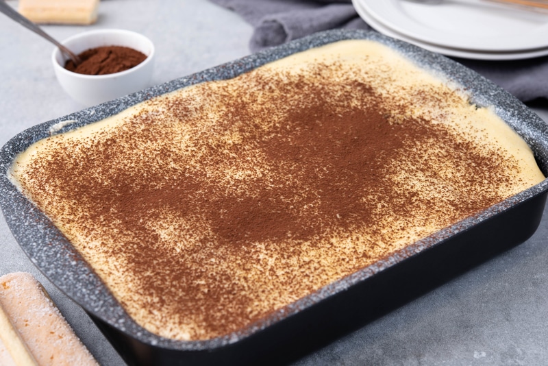 sprinkle cocoa powder on tiramisu