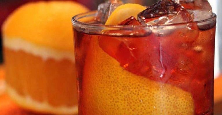 Side view Americano cocktail with orange and ice