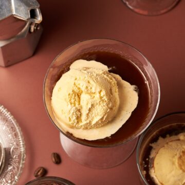 picture of affogato next to coffee beans and coffe maker