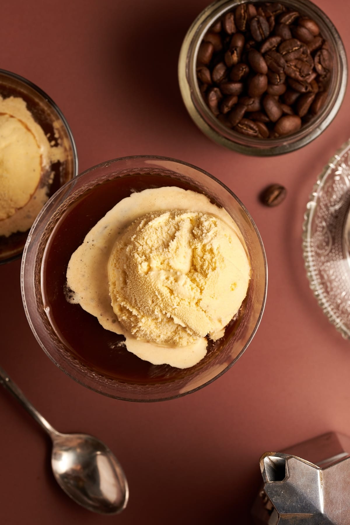 picture of affogato al caffe dessert in a cup next to coffee beans