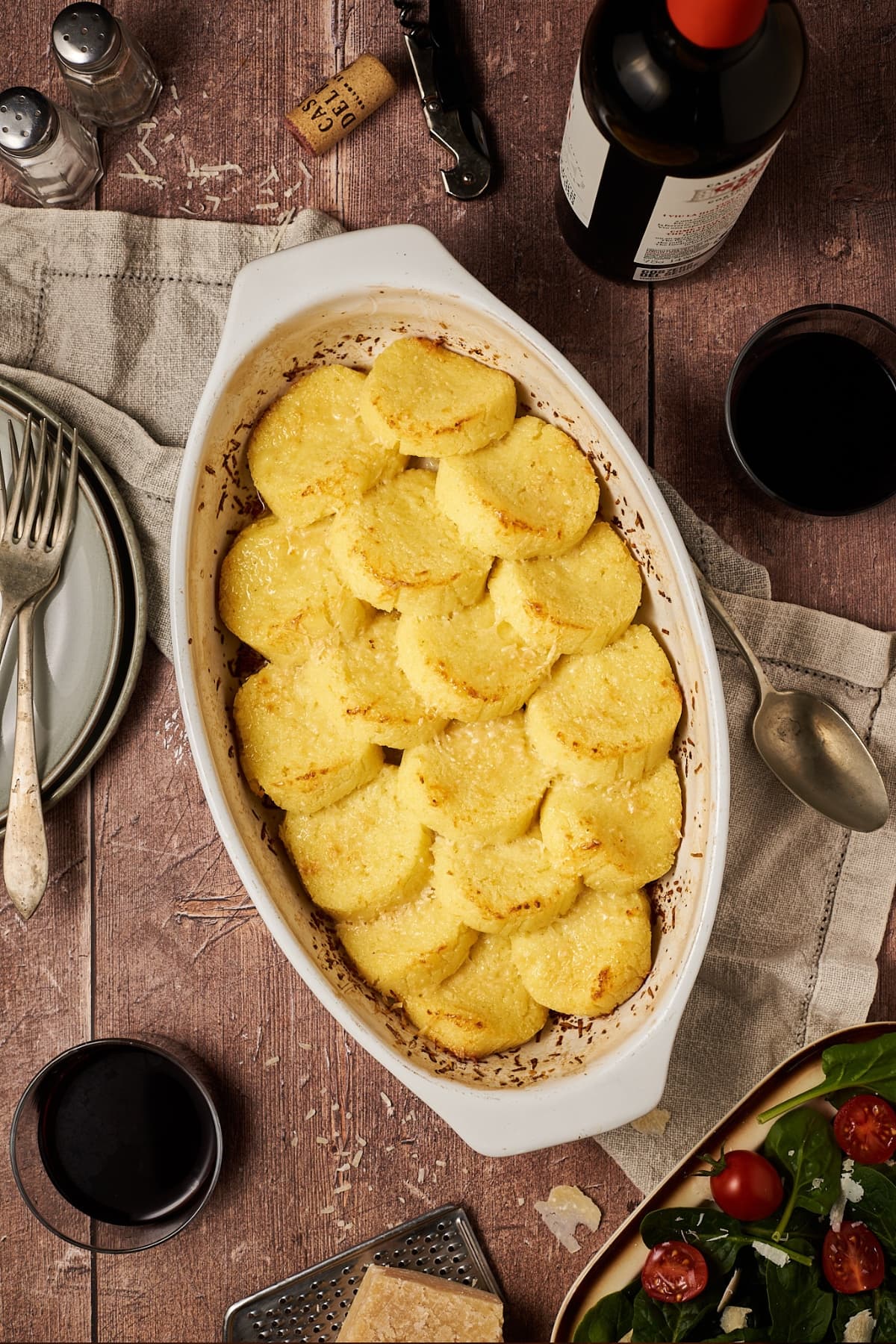 gnocchi alla romana recipe on a table in a oval baking dish