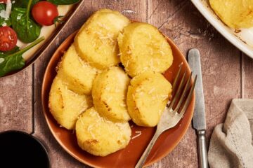 a dish of gnocchi alla romana served in a dish on a table