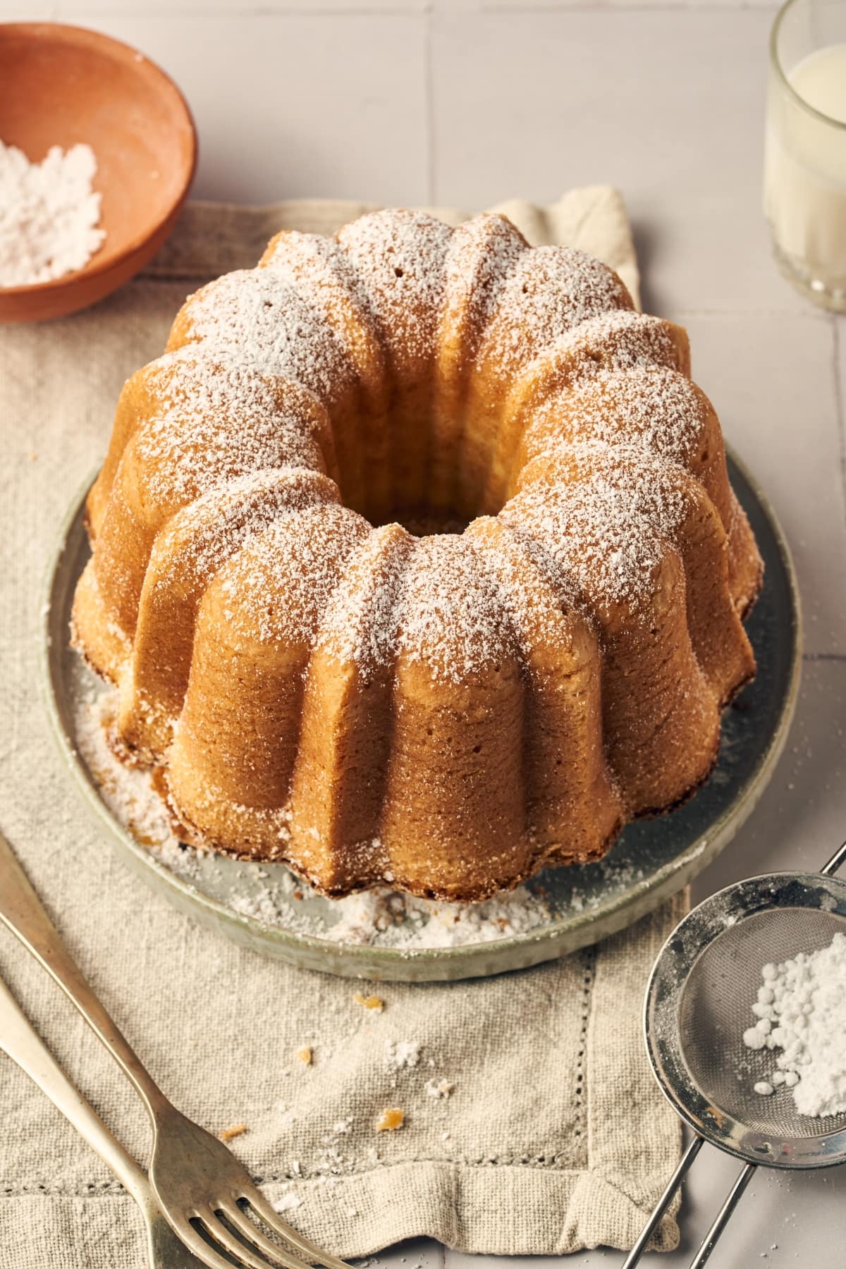 baked ciambella italian cake dusted with powdered sugar on a plate 