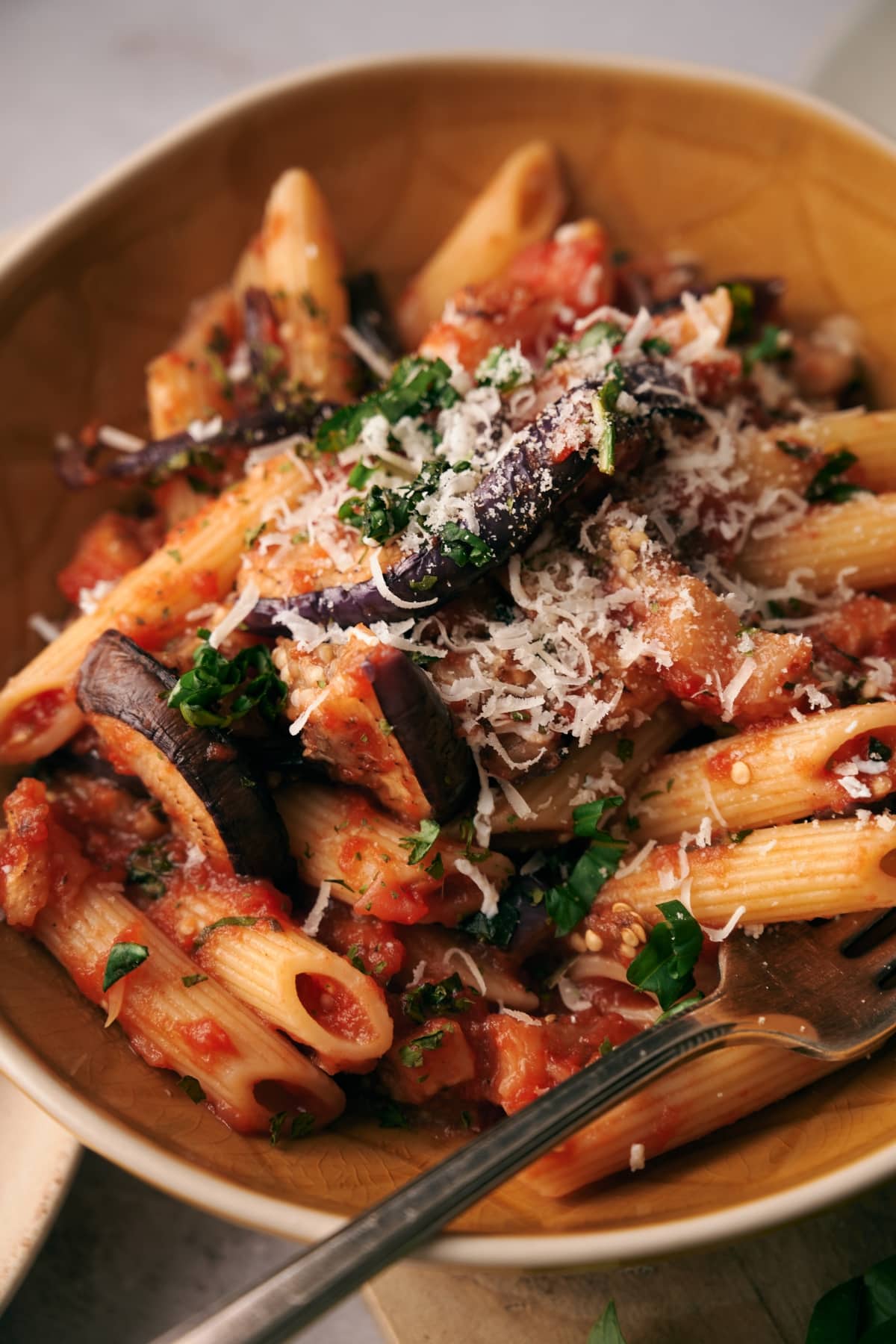 pasta alla norma with grated salted ricotta cheese on top