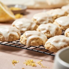 Frosted ricotta cookies on a wire rack.