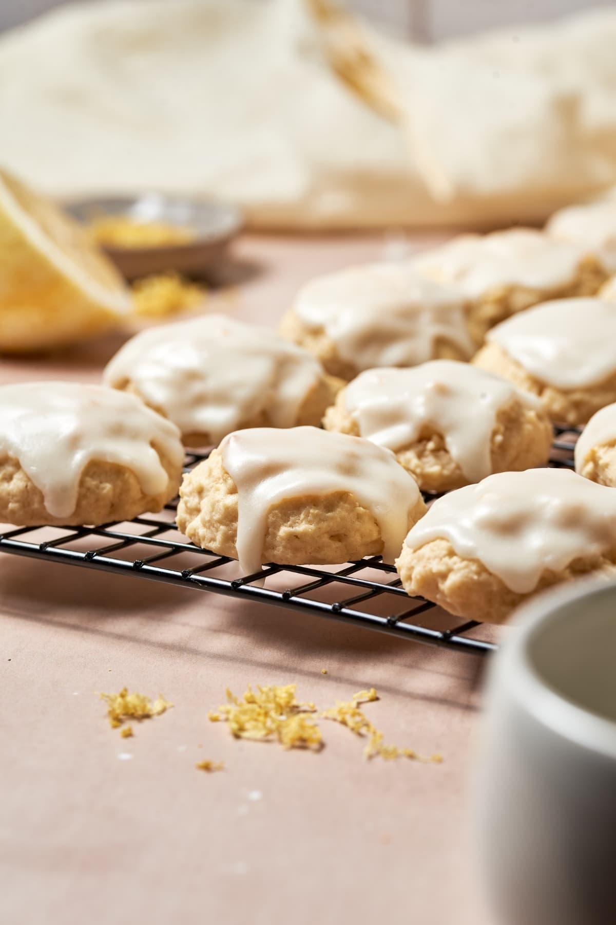 Frosted ricotta cookies on a wire rack.