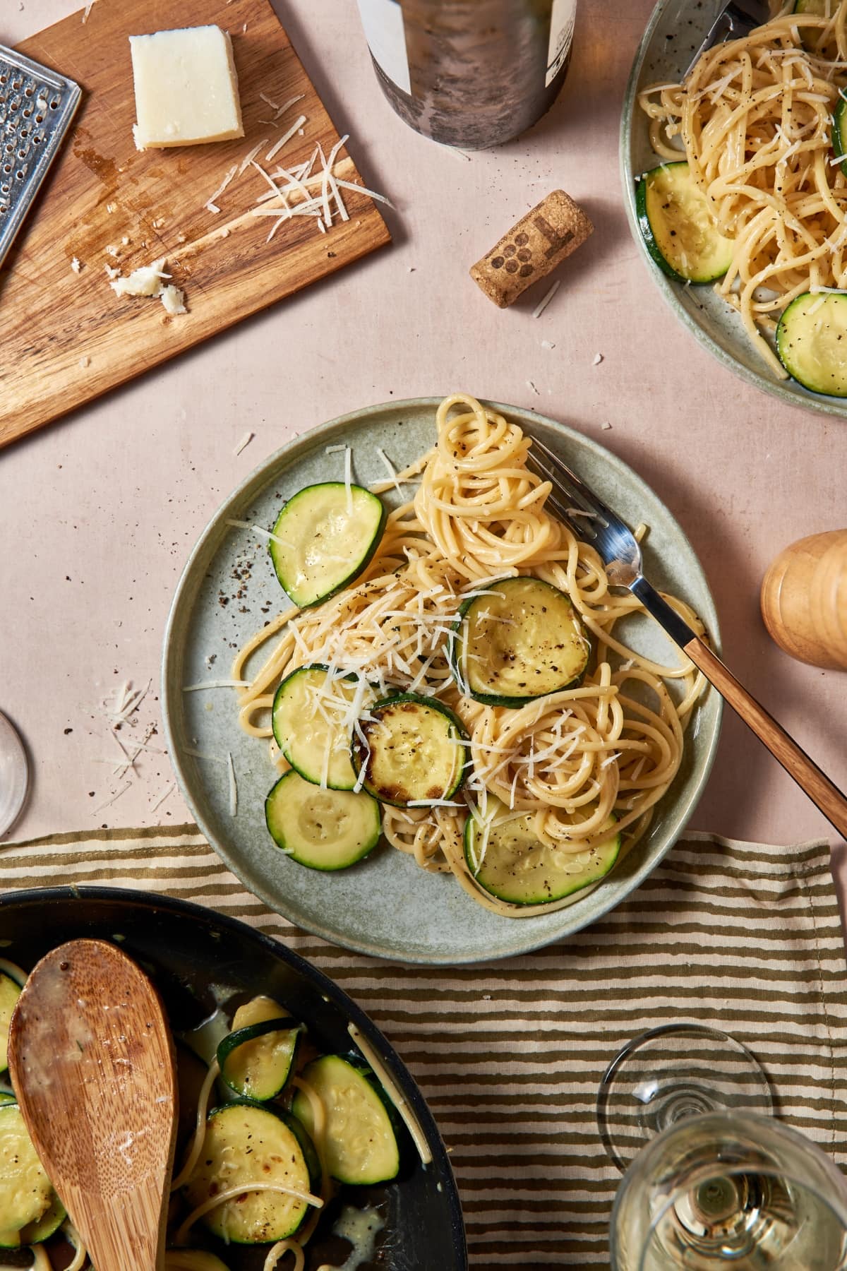 Vegetarian carbonara on a serving dish next to some pecorino romano.