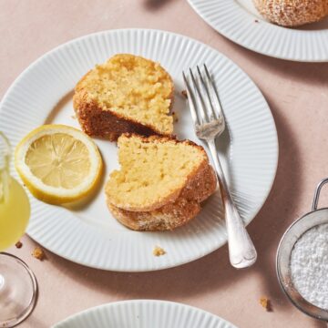 slices of limoncello cake on a white plate with a slice of lemon and a fork