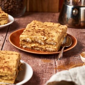 slice of pumpkin tiramisu on an orange plate