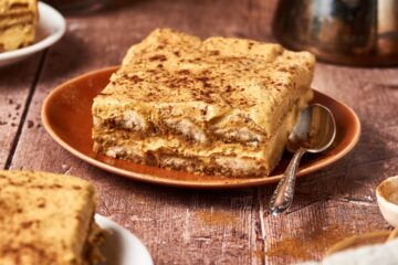 slice of pumpkin tiramisu on an orange plate