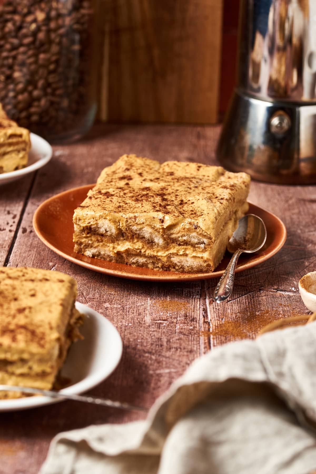 slice of pumpkin tiramisu on an orange plate