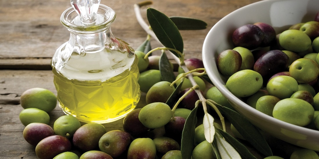 olive oil on table with olives