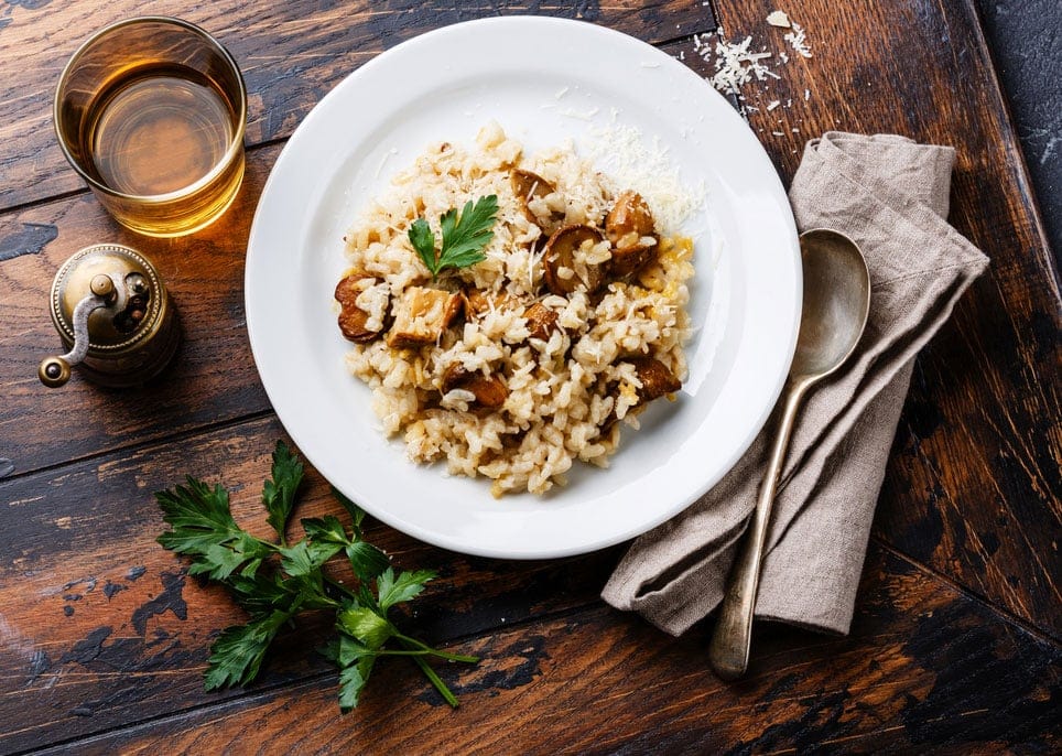 Risotto with porcini mushroom on wooden table